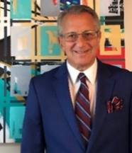 A person wearing a suit and tie

Description automatically generated